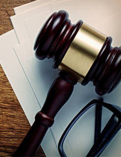Gavel Sitting On Top Of Papers